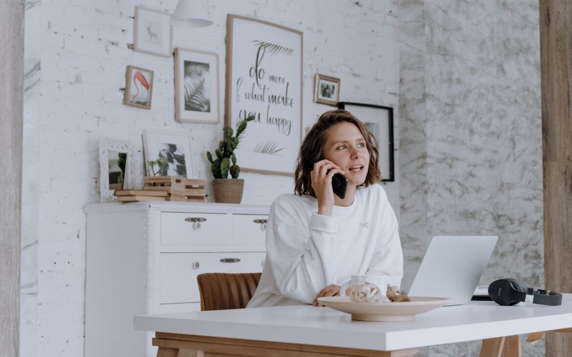 White shirt woman at desk working remotely