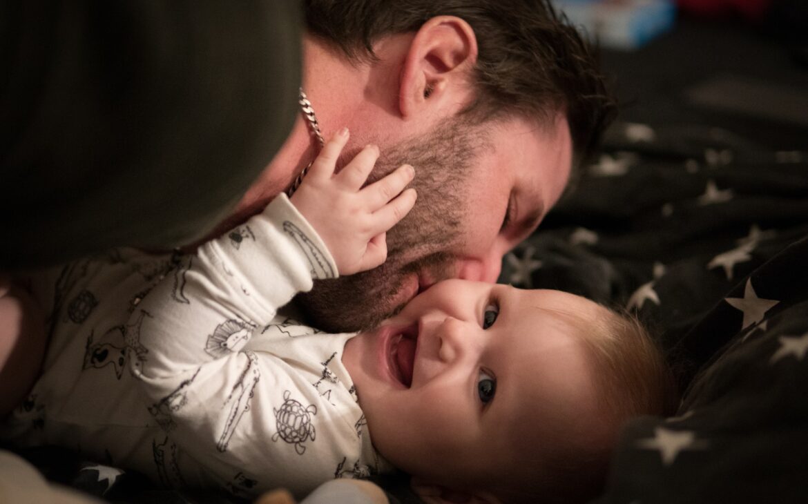 dad kissing baby, baby smiling